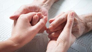 holding hands in hospice